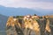 Stone monastery in the mountains. Kalabaka, Greece summer cloudy day in Meteora mountain valley.
