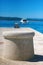 Stone mooring bollard. Travel concept