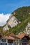 Stone mountain and forest rising above quaint houses in Interlaken