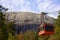 STONE MOUNTAIN, GEORGIA, USA - MARCH 19, 2019: Red Skyride cable car in front of Stone Mountain Summit with famous rock relief.