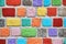 Stone multicolored wall. Brick painted background in colors of the rainbow.