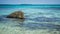 Stone on the narrow beach sea with blue and green turqoise water on beach in karimun jawa