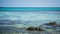 Stone on the narrow beach sea with blue and green turqoise water on beach in karimun jawa