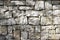 Stone natural wall of different blocks. The texture of the stone lined with blocks of natural