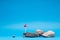 A stone next to a cliff sign, on blue background