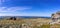 Stone outcrops on a mountain plateau. Beautiful panorama of the blue cloudy sky and mountain ranges and valleys. Northern Ural in