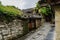 Stone passageway between ancient tile-roofed houses in cloudy sp