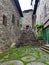 Stone path with grass in the middle of stone buildings