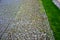 Stone path lined with regular granite cubes the center of the path is made of irregular granite sections around the lawn park park