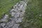 A stone path in the park and a granite staircase with steps. Stone steps in the garden