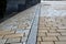 Stone paving of squares and streets of various formats and sizes and colors of cubes. folding in rows, mosaics, or arcs that form