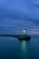 Stone pier in Darlowo in the evening. Lights on the beach. Traffic lights in the port. Blue hour. Poland