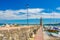 Stone pier mole with lighthouse, street lights and yachts on boat parking port marina in Desenzano del Garda