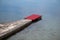 Stone pier with red carpet at waterfront, luxury beach