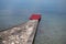 Stone pier with red carpet at waterfront, luxury beach concept