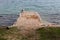 Stone pier surrounded with windy sea