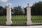 Stone pillar and decorative wrought iron fence gate