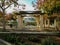 Stone pillared gazebo, with green metal roof in park