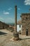 Stone pillory in front of old stone houses at Monsanto