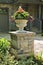 Stone planter in front of house