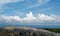 Stone podium on nature background with clouds and copy space