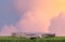 Stone podium table top on green grass with outdoor soft pink blue sky pastel cloudscape at sunrise nature background.Beauty