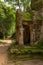 Stone portico covered with moss among trees