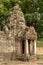 Stone portico with decorative tower in trees