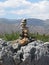 A stone pyramid against the backdrop of mountains