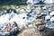 Stone pyramid cairn near river, buddhism