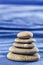 Stone pyramid over blue blurred background