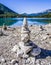 Stone pyramids, little man, mound, ovoo, Inukshuk made near the lake or the mountain river