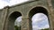 Stone railway arch bridge, high old viaduct. Transport construction, historical architecture