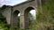 Stone railway arch bridge, high old viaduct. Transport construction, historical architecture
