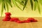 Stone red pebble laid on a wooden floor and stacked on several columns in zen lifestyle on green background