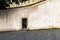 Stone retaining wall with an entrance to a restaurant and a cafe on top of a hill