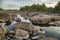 Stone river bed. The entire space between the boulders is filled with water.