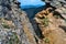 stone rock gorge with colored red moss with grass on a sharp ridge in the Baikal green mountains, Siberia, Hamar-Daban