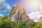 stone rock mountain against blue summer sky