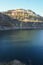 Stone rocks near water, on the background of lake, river, sea, ocean. Blue clear water. Artificial reservoirs