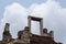 Stone ruin of ancient temple top in Angkor Wat, Cambodia. Ancient temple on sky background.