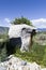 Stone sculpture of a bear getting a drink of water