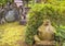 Stone sculpture covered by moss depicting a Tanuki racoon-dog in the Tamonji Temple.