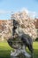 A stone sculpture of a woman on the background of a blooming magnolia at the Bruhl Palace in Brody