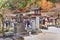 Stone sculptures and lanterns adorned with komainu dogs or shishi lions in the Japanese Dazaifu shrine.