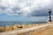 Stone seaside with iron street lantern on cloudy day. Adriatic seascape. Italian panoramic coastline. Italian south background.