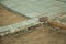 Stone setts blocks being sand-seated in a construction site