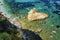 Stone in the shape of a heart in the turquoise sea. Beautiful landscape. Close-up