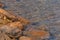 Stone shore of the lake Wakatipu, Queenstown, New Zealand