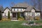 Stone and siding two-story home with flowers in the yard